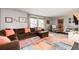 Comfortable living room with sectional sofa, neutral paint, and ample natural light from large windows at 4645 W Temple Pl, Denver, CO 80236