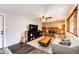 Comfortable living room with brick fireplace, ceiling fan, modern furniture, and hardwood floors at 4645 W Temple Pl, Denver, CO 80236