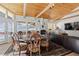 Dining area with a large round wooden table, comfortable chairs, vaulted ceilings, and a view to the outside at 1053 Red Moon Rd, Evergreen, CO 80439