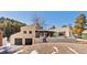 Beige, single-story home featuring a two-car garage and a stone pathway leading to the front door at 1053 Red Moon Rd, Evergreen, CO 80439