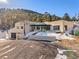 Stunning home exterior with a unique architectural design, complemented by a well-maintained gravel driveway at 1053 Red Moon Rd, Evergreen, CO 80439