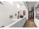 Bright hallway featuring skylights, terracotta tile flooring, and a custom built-in console with ample storage at 1053 Red Moon Rd, Evergreen, CO 80439