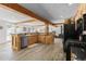 Bright kitchen featuring beams, wood cabinets, stone countertops, stainless steel appliances and wood-look floors at 1053 Red Moon Rd, Evergreen, CO 80439