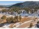 Scenic wooded property featuring a mix of evergreens and snow-covered landscape in a mountain setting at 1053 Red Moon Rd, Evergreen, CO 80439