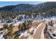 Scenic wooded property featuring a mix of evergreens and snow-covered landscape in a mountain setting at 1053 Red Moon Rd, Evergreen, CO 80439