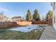 Large backyard with a wooden fence and patio at 9488 Brook Ln, Lone Tree, CO 80124