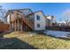 Home's backyard, featuring a deck and stairs at 9488 Brook Ln, Lone Tree, CO 80124