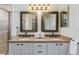 Bathroom featuring a double vanity and granite countertop at 9488 Brook Ln, Lone Tree, CO 80124