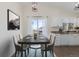 Kitchen dining area with table and chairs, and access to a deck at 9488 Brook Ln, Lone Tree, CO 80124