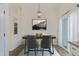 Formal dining area with chandelier and adjacent built-in shelving at 9488 Brook Ln, Lone Tree, CO 80124