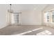 Empty dining room with carpet and large windows at 9488 Brook Ln, Lone Tree, CO 80124