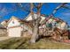 Ranch-style home with a wooden deck and landscaping at 9488 Brook Ln, Lone Tree, CO 80124