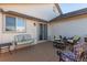 Back patio with awning, seating area and access to house at 9488 Brook Ln, Lone Tree, CO 80124