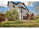The backyard features a well-maintained lawn, a wood deck with stairs, and white siding at 10938 Mcclellan Rd, Parker, CO 80134
