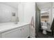 Bright bathroom features a white vanity, mirror, and a shower with a curtain near a window at 10938 Mcclellan Rd, Parker, CO 80134