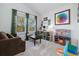Comfortable playroom with brown couch, shelves filled with toys, and a large window at 10938 Mcclellan Rd, Parker, CO 80134