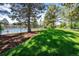 Community pool and playground viewed from behind a fenced grassy lawn on a sunny day at 10938 Mcclellan Rd, Parker, CO 80134