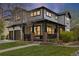Charming two-story home with a covered front porch, landscaped lawn, and a two-car garage at 10938 Mcclellan Rd, Parker, CO 80134