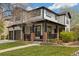 Charming two-story home with a covered front porch, landscaped lawn, and a two-car garage at 10938 Mcclellan Rd, Parker, CO 80134