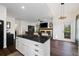 Modern kitchen with a view to the living room with sleek countertops and updated appliances at 10938 Mcclellan Rd, Parker, CO 80134