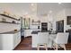 Bright kitchen featuring a large kitchen island, modern appliances and open shelving at 10938 Mcclellan Rd, Parker, CO 80134