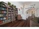 Grand living room featuring a floor to ceiling bookshelf and staircase leading to the second floor at 10938 Mcclellan Rd, Parker, CO 80134