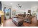 Spacious living room featuring a large sectional sofa, hardwood floors, and lots of natural light through the windows at 10938 Mcclellan Rd, Parker, CO 80134