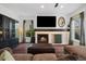 Cozy living room features a fireplace with a dark wood mantel, hardwood floors, and plenty of natural light at 10938 Mcclellan Rd, Parker, CO 80134