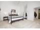 Large main bedroom with a four-poster bed, neutral carpet, and a view into the ensuite bath and walk-in closet at 10938 Mcclellan Rd, Parker, CO 80134