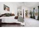 Bright, spacious main bedroom with a four-poster bed, neutral carpet, and a walk-in closet with custom shelving at 10938 Mcclellan Rd, Parker, CO 80134