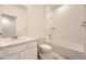 Bright bathroom featuring a white vanity, large mirror, and shower-over-tub combination with tiled surround at 2002 S Haleyville Way, Aurora, CO 80018