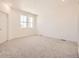 Bright bedroom featuring plush carpeting and a large window at 2002 S Haleyville Way, Aurora, CO 80018