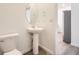Elegant powder room featuring modern fixtures and pedestal sink at 2002 S Haleyville Way, Aurora, CO 80018