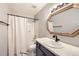 Bathroom featuring shower over bath, and single vanity at 2575 S Syracuse Way # H106, Denver, CO 80231