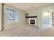 Inviting living room with a cozy fireplace, large windows, and neutral carpeting at 2575 S Syracuse Way # H106, Denver, CO 80231