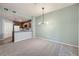 Open living area with modern lighting, neutral colors, and access to the kitchen at 2575 S Syracuse Way # H106, Denver, CO 80231