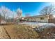 Large backyard with trampoline, slide, and partial house view at 1331 4Th St, Fort Lupton, CO 80621