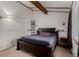 King-size bed in bedroom with high ceiling and window at 1331 4Th St, Fort Lupton, CO 80621