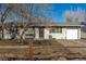 House exterior showcasing a front yard, driveway, and mature trees at 1331 4Th St, Fort Lupton, CO 80621