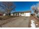 Ranch style home with a single car garage and mature landscaping at 1331 4Th St, Fort Lupton, CO 80621