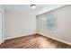 Bright bedroom featuring hardwood floors and a large window at 16700 Alzere Pl, Parker, CO 80134