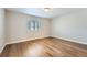 Simple bedroom with hardwood floors and a window with blinds at 16700 Alzere Pl, Parker, CO 80134