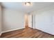 Well-lit bedroom with hardwood floors and double door closet at 16700 Alzere Pl, Parker, CO 80134