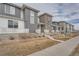 Row of townhomes showcasing modern design, stone accents, and landscaping at 16700 Alzere Pl, Parker, CO 80134