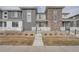 Townhome features stone accents, gray siding, and a front walkway leading to the entrance at 16700 Alzere Pl, Parker, CO 80134