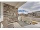 Inviting front porch with stone accents and view of the neighborhood at 16700 Alzere Pl, Parker, CO 80134