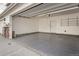 Spacious garage with epoxy flooring and storage shelving at 16700 Alzere Pl, Parker, CO 80134