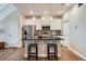 Eat-in kitchen with white cabinets and granite island at 16700 Alzere Pl, Parker, CO 80134