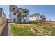 Spacious backyard with healthy green grass and a view of the back of the home with a balcony at 6646 Merrimack Dr, Castle Pines, CO 80108