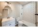 Bathroom showcasing updated vanity, round mirror, and modern tiled shower with glass door at 6646 Merrimack Dr, Castle Pines, CO 80108